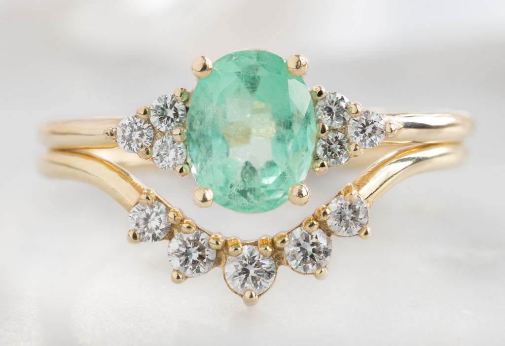 The Ivy Ring with an Oval-Cut Emerald with Round Diamond Sunburst Stacking Band