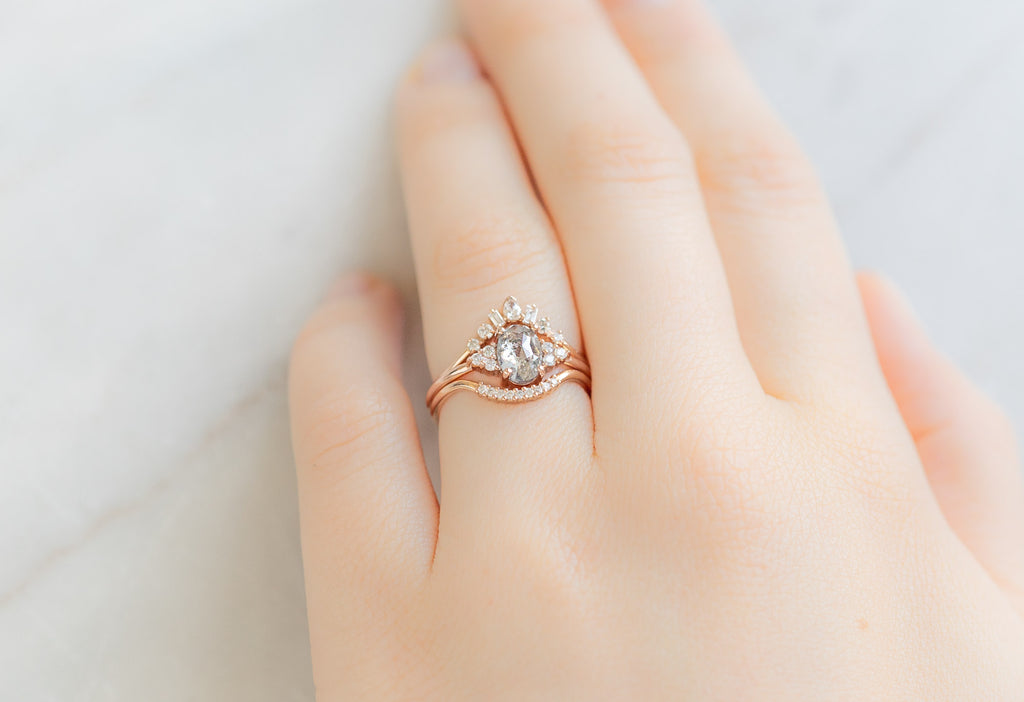 The Ivy Ring with an Oval-Cut Salt and Pepper Diamond with White Diamond Stacking Bands on Model