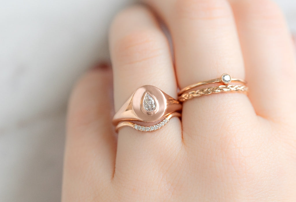 The Pear-Cut White Diamond Signet Ring Stacked on Model