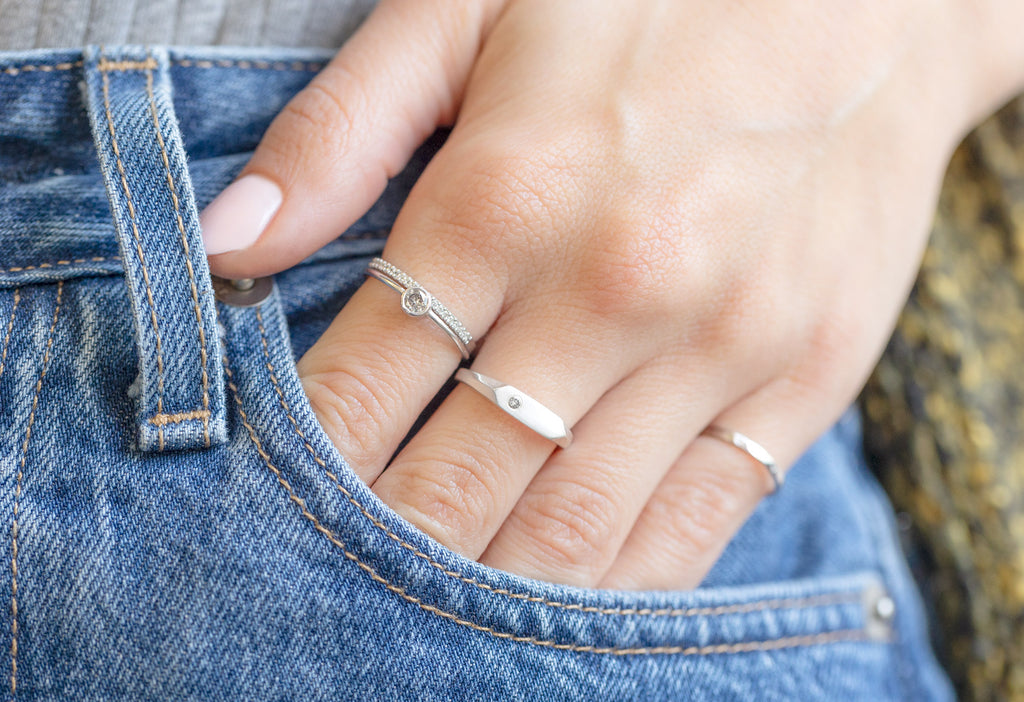 The Salt and Pepper Diamond Signet Ring Stacked on Model with hand in jean's pocket