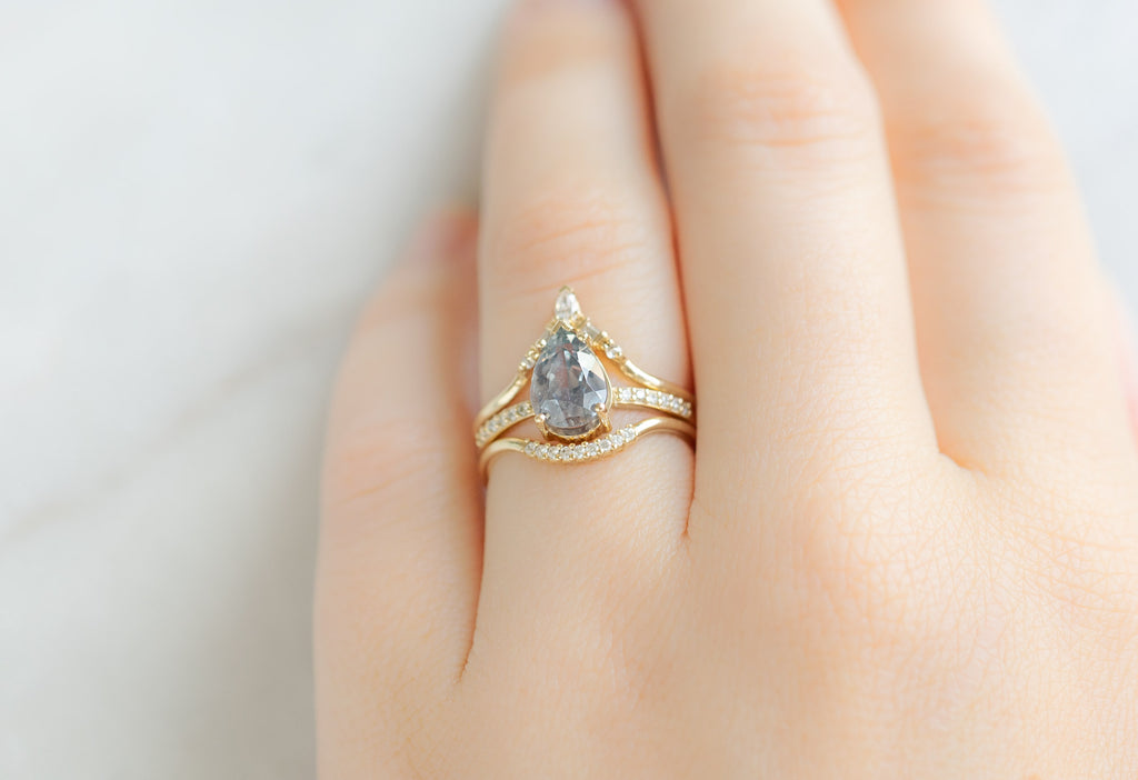 The Willow Ring with a Pear-Cut Lavender Sapphire with White Diamond Stacking Bands on Model
