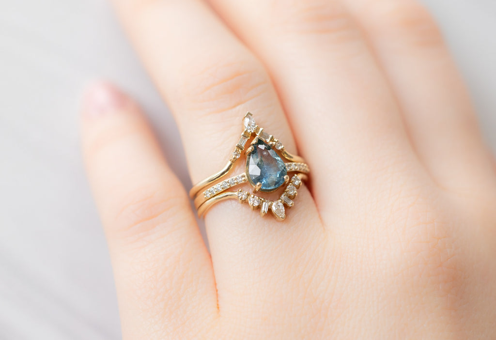 The Willow Ring with a Pear-Cut Montana Sapphire with White Diamond Stacking Bands on Model