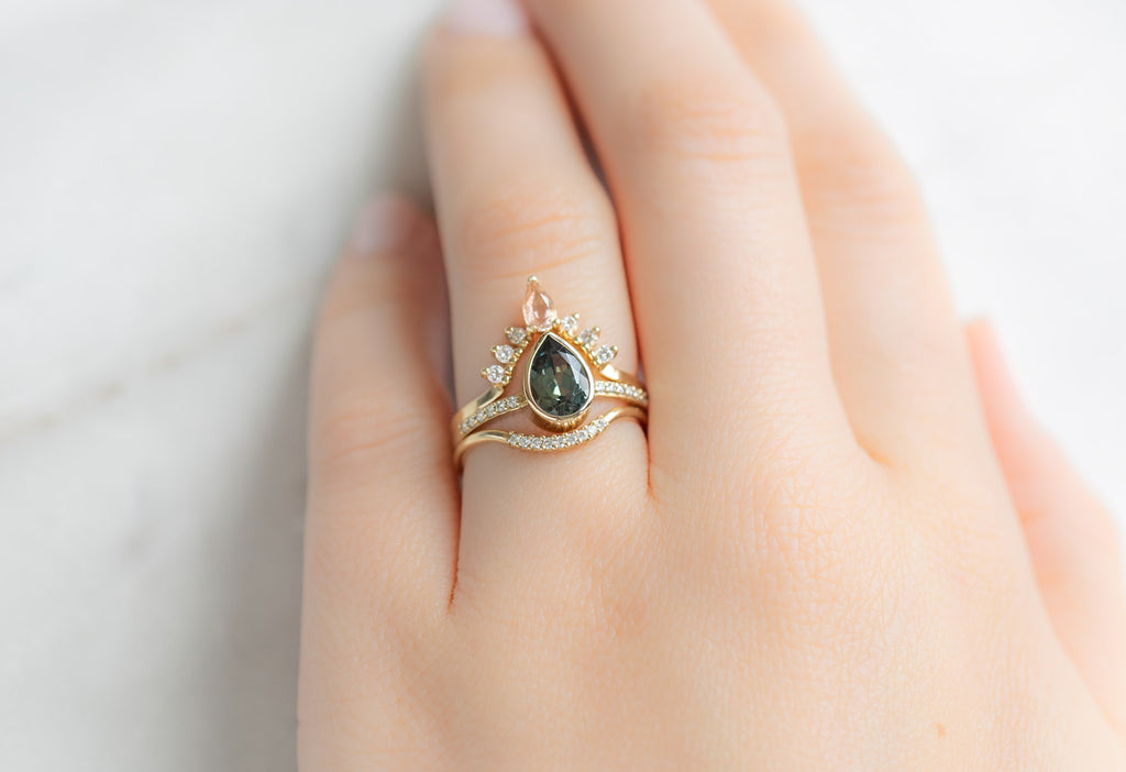 The Willow Ring with a Pear-Cut Sapphire with Stacking Bands on Model