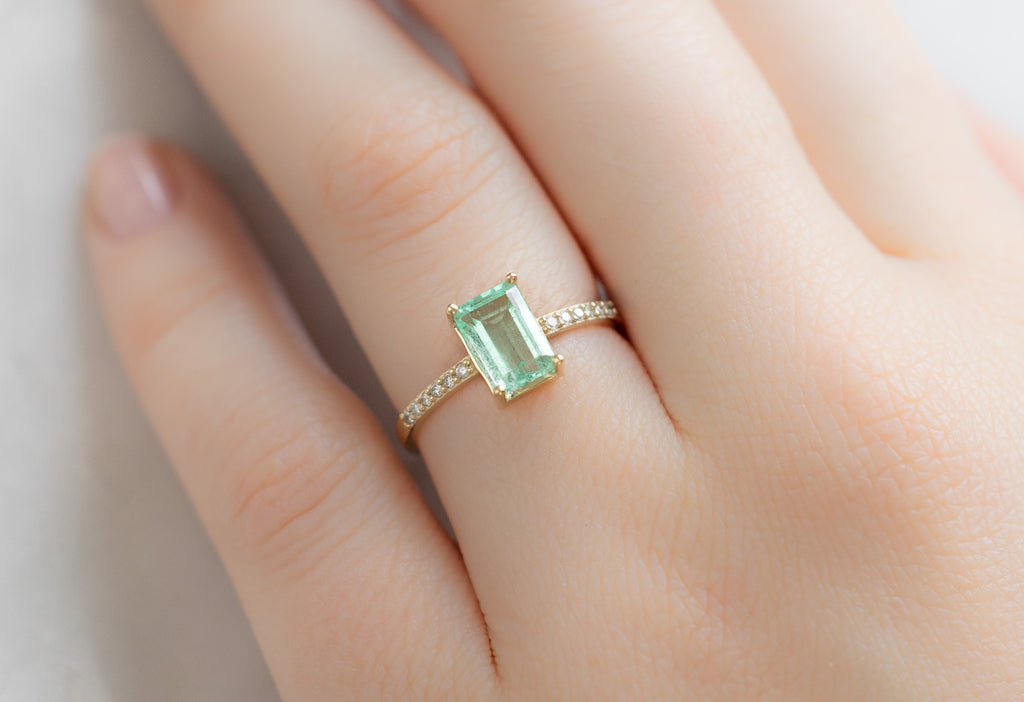 The Willow Ring with an Emerald-Cut Emerald on Model