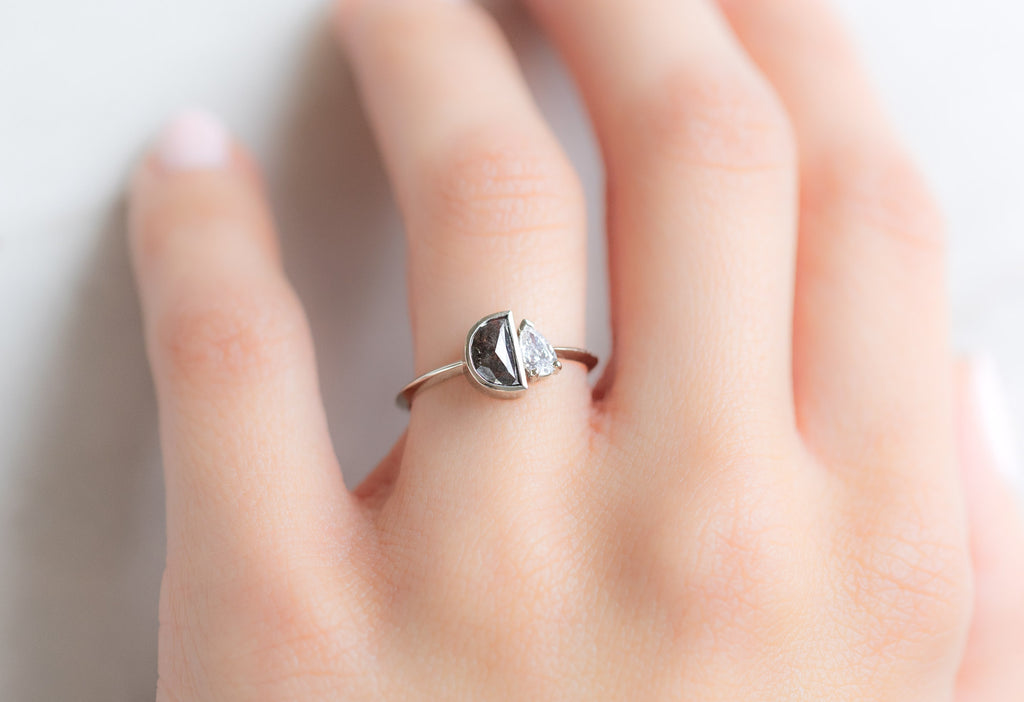 The You & Me Ring with a Black Half-Moon + Pear-Cut White Diamond on Model
