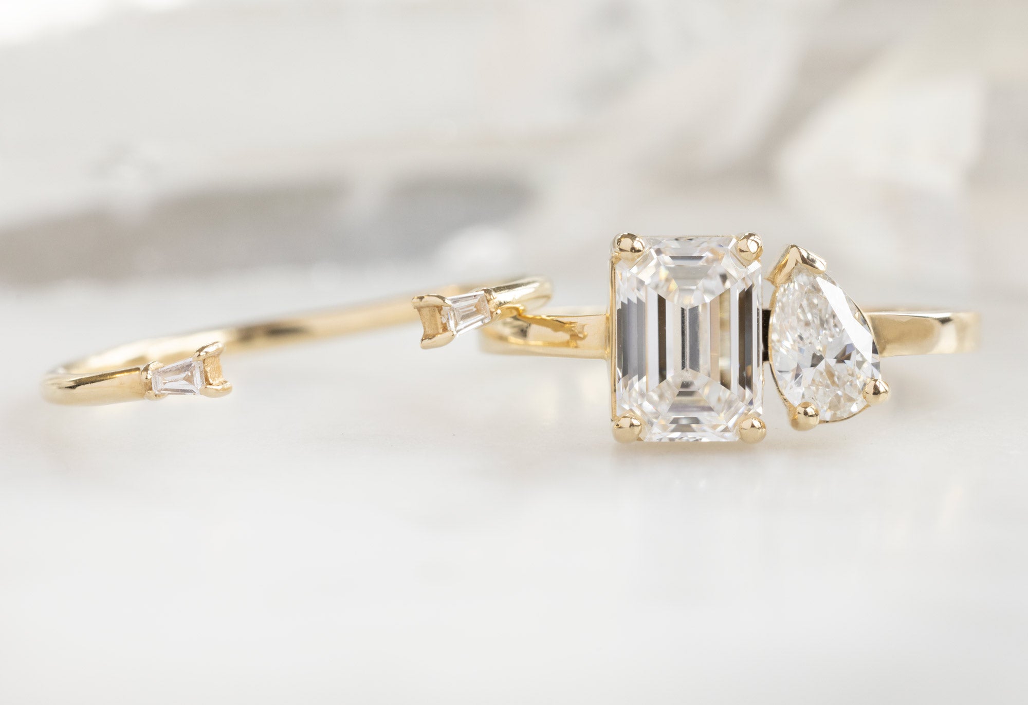 The You & Me Ring with an Emerald-Cut Lab Grown + White Diamond with Open Cuff Baguette Stacking Band
