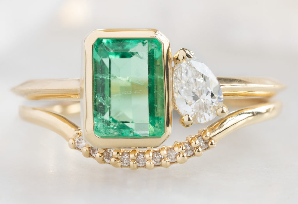 The You & Me Ring with an Emerald + White Diamond with Pavé Arc Stacking Band