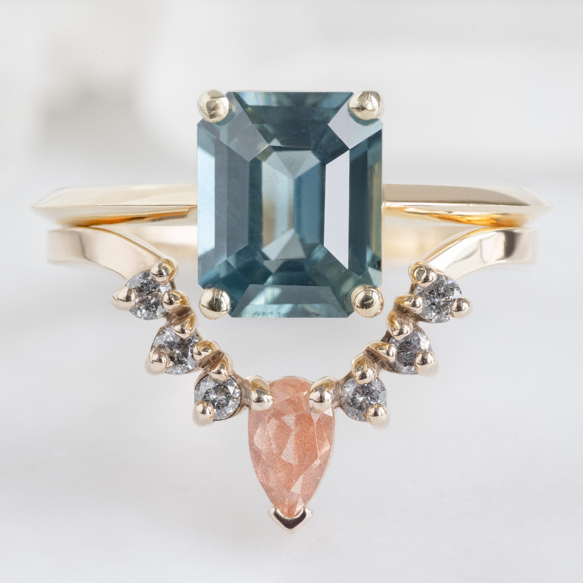 One of a Kind Sunstone and Salt and Pepper Diamond Sunburst Stacking Band in 14K yellow Gold Stacked with an Emerald-Cut Sapphire Engagement Ring