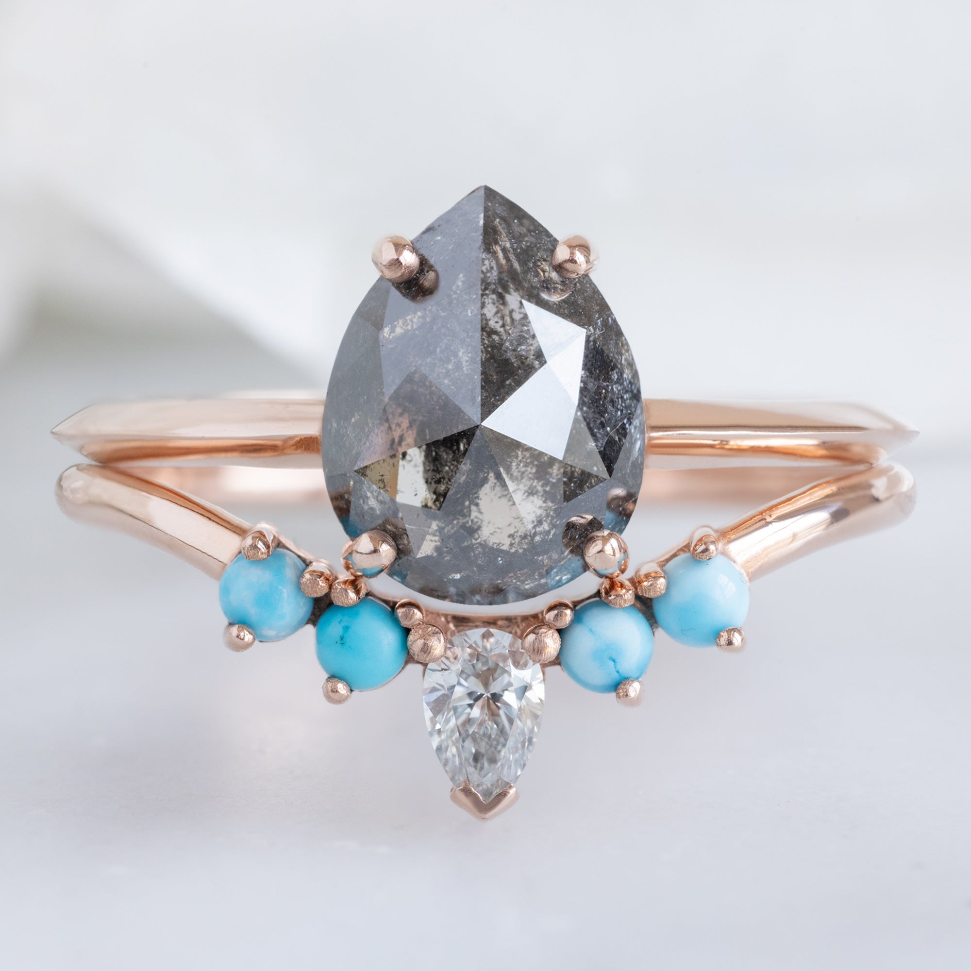 White Diamond and Turquoise 4-Stone Sunburst Stacking Band in 14K Rose Gold Stacked with Black Diamond Pear Engagement Ring