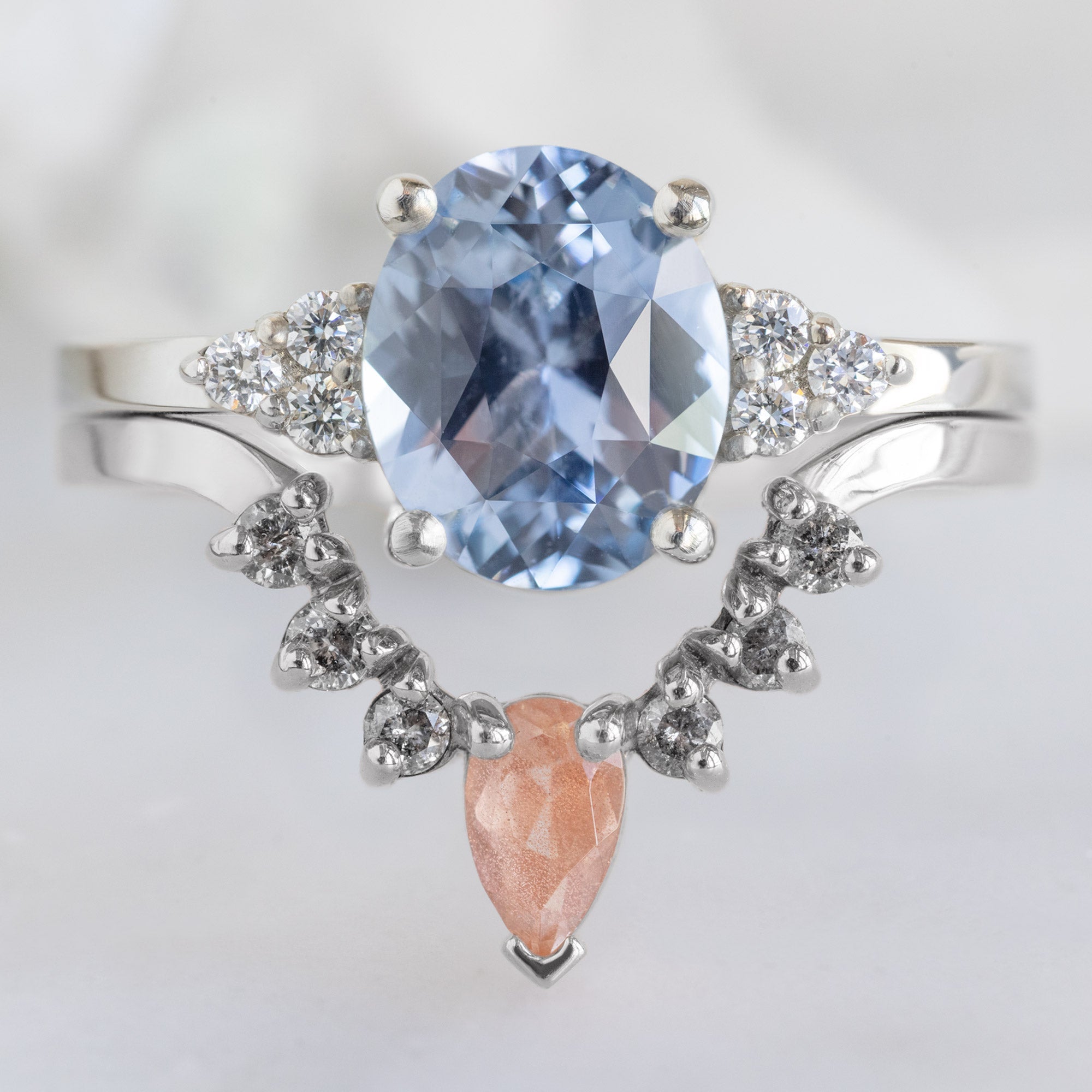 One of a Kind Sunstone and Salt and Pepper Diamond Sunburst Stacking Band in 14K White Gold Stacked with Oval Sapphire Engagement Ring