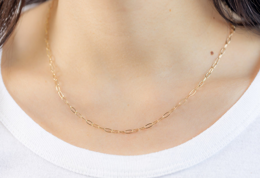 Yellow Gold Drawn Cable Chain Charm Necklace on Model wearing white boatneck shirt