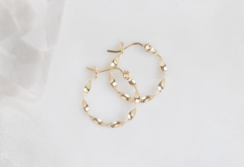 15mm Yellow Gold Ribbon Hoops Flat on Marble