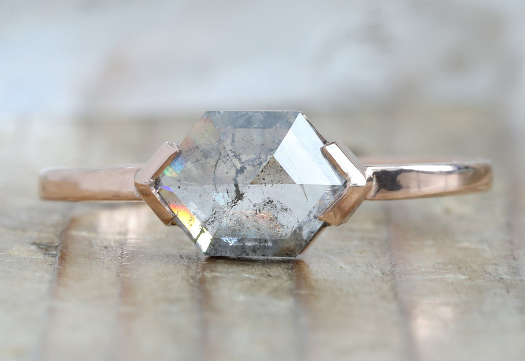 The Sage Ring with a Salt and Pepper Hexagonal Diamond on Wood Table