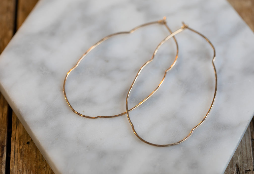 Organic Hoop Earrings on White Marble Tile