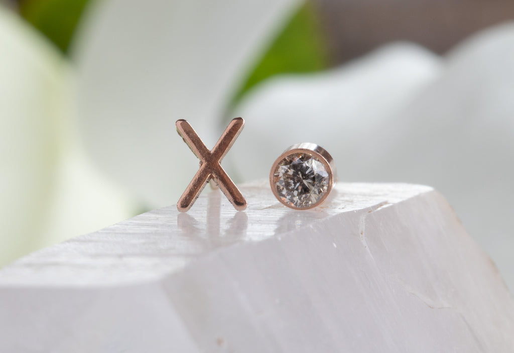 rose gold 'xo' diamond studs on white crystal