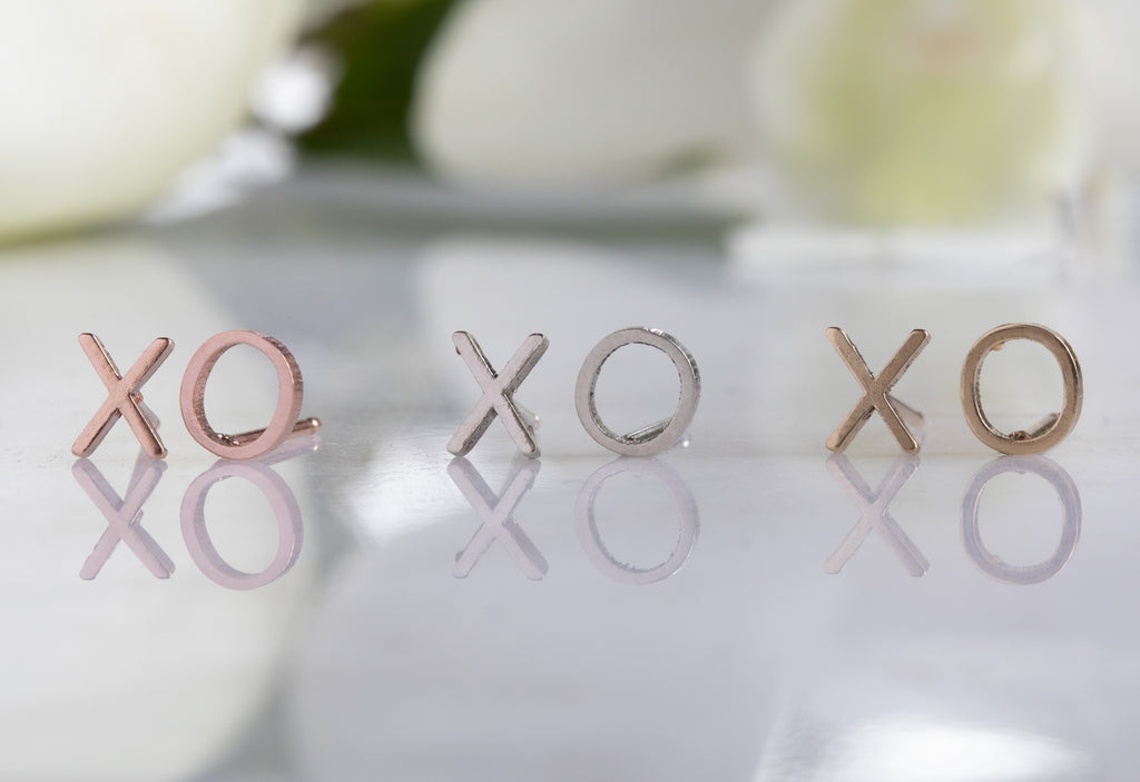 three pairs of 'xo' stud earrings in all metal options