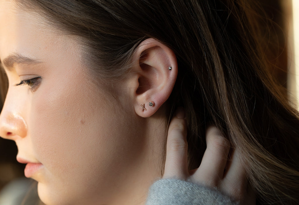 model wearing 'xo' diamond stud earrings