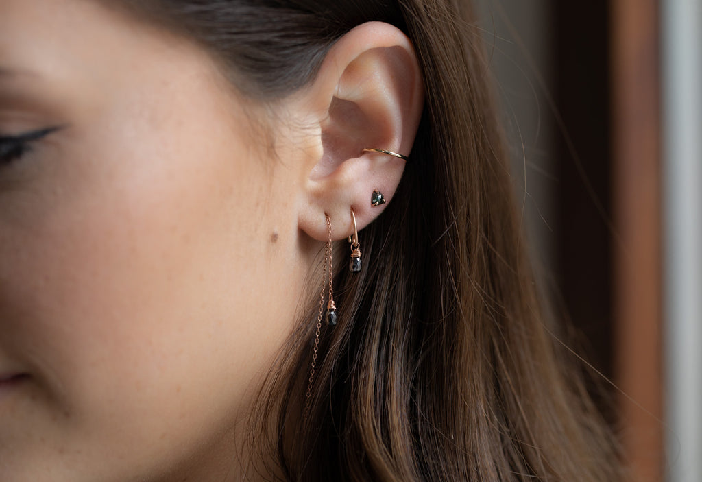 simple diamond drop threader earrings stacked on model
