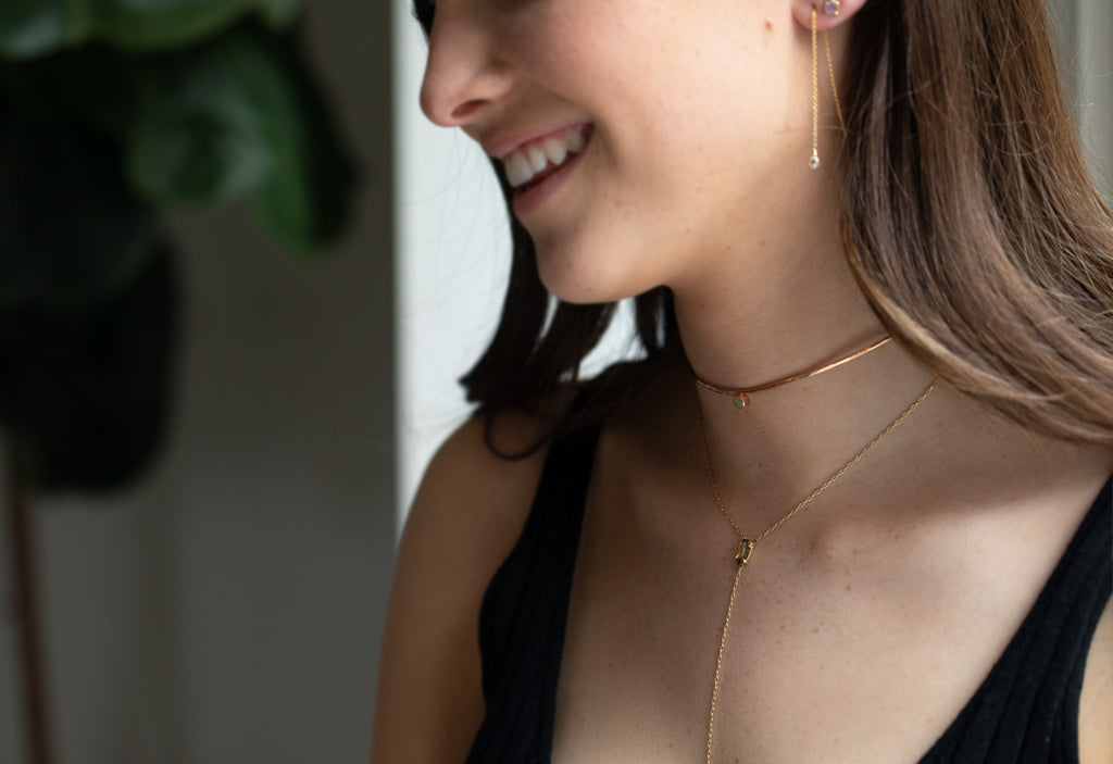 simple diamond drop threader earrings on model smiling