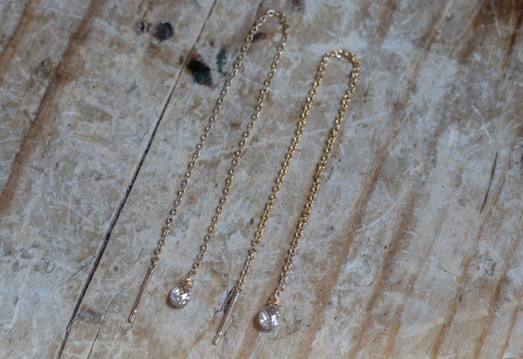 simple diamond drop threader earrings on wooden table