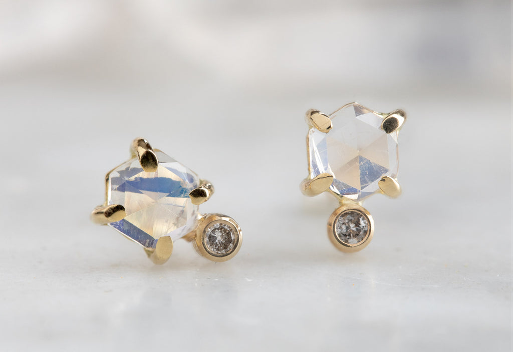 Moonstone Hexagon + Diamond Stud Earrings on white marble tile