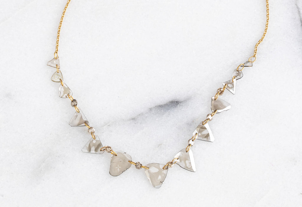 Yellow Gold Diamond Slice Pennant Necklace on White Marble Tile