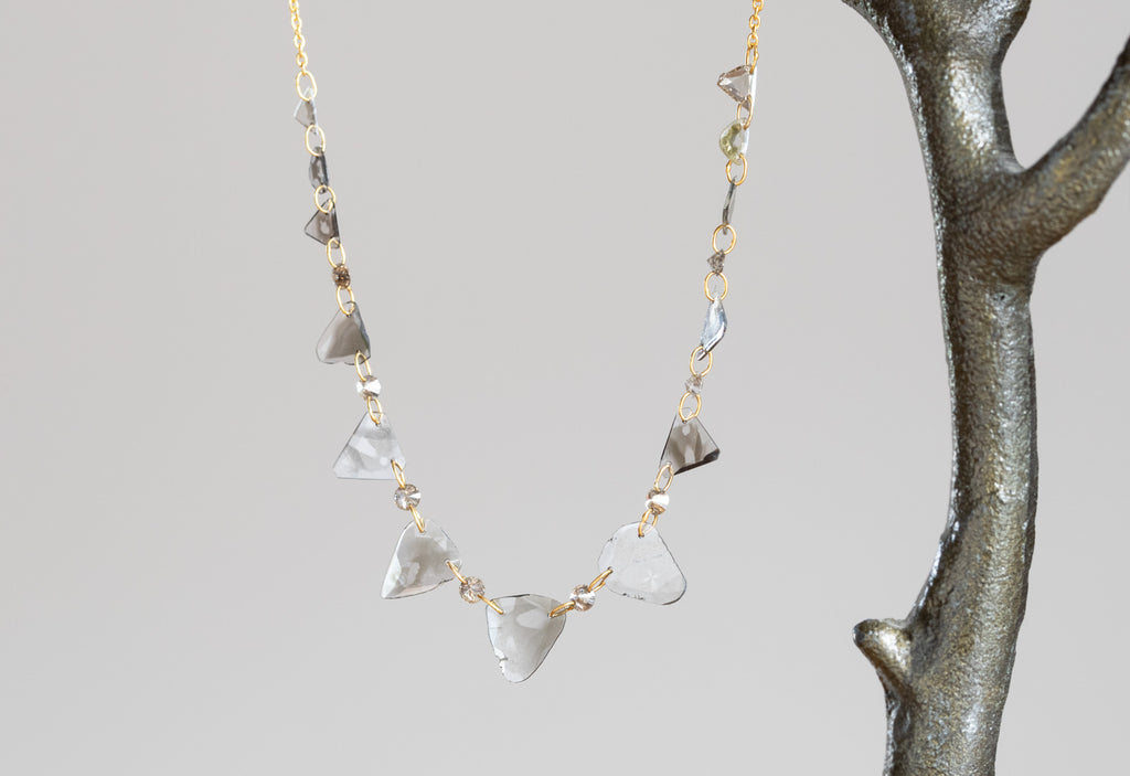Yellow Gold Diamond Slice Pennant Necklace hanging on Steel Earring Tree