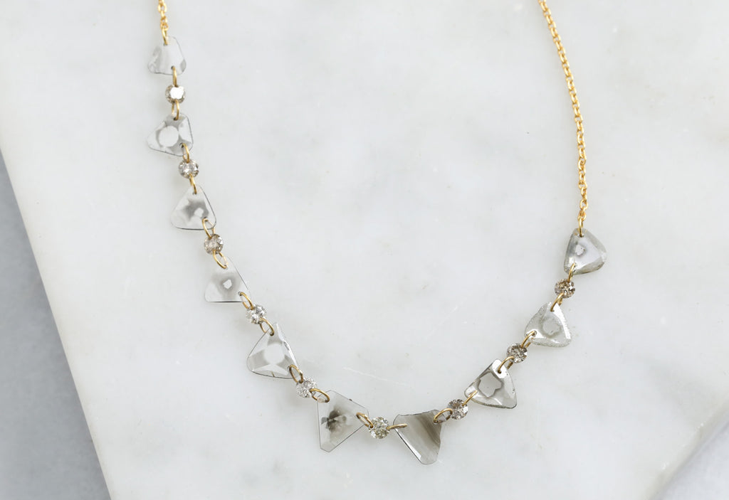 YEllow Gold Yellow Gold Diamond Slice Pennant Necklace on White Marble Tile