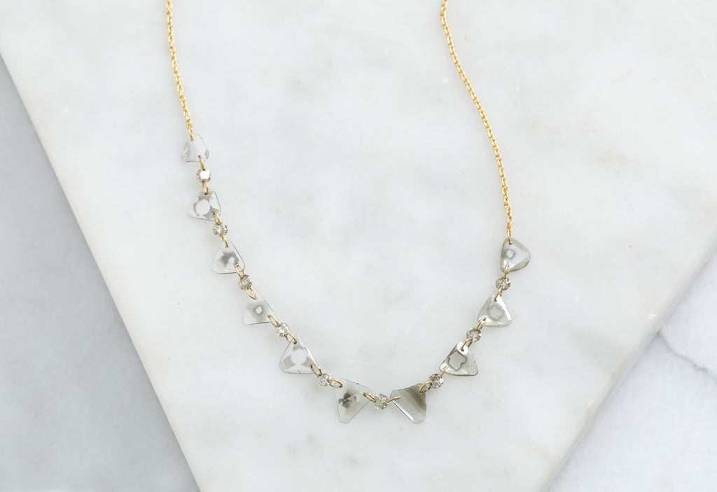 Yellow Gold Diamond Slice Pennant Necklace on White Marble Tile
