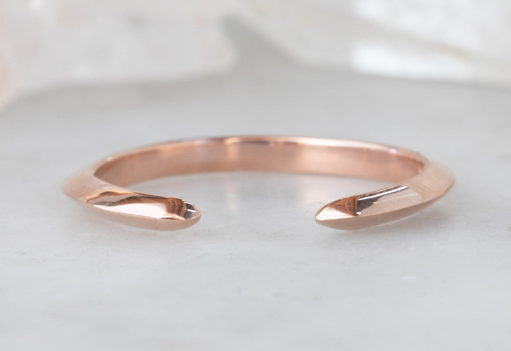 Rose Gold Open Cuff Knife Edge Wedding Band on White Marble Tile