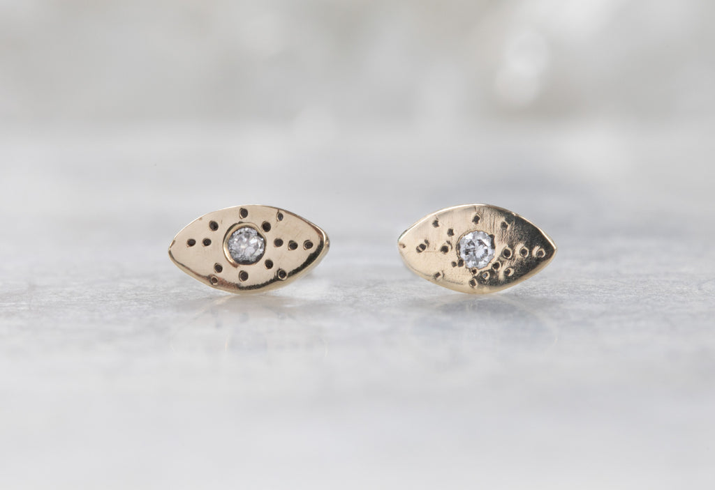 yellow gold Marquise Stardust Stud Earrings on white marble tile