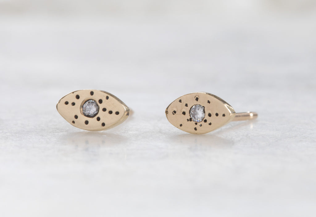 yellow gold Marquise Stardust Stud Earrings on white marble tile