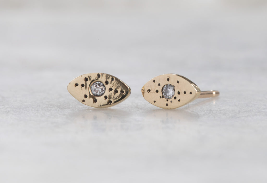 yellow gold Marquise Stardust Stud Earrings on white marble tile