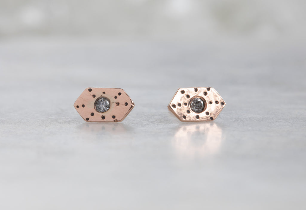 rose gold Hexagon Stardust Stud Earrings on white marble tile