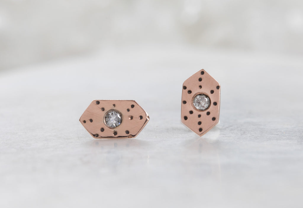 rose gold Hexagon Stardust Stud Earrings on white marble tile