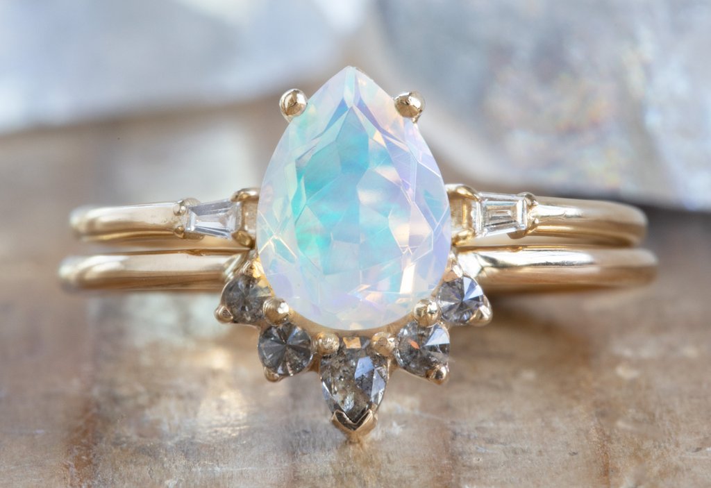 The Aster Ring with a Pear-Cut Opal stacked with open cuff baguette stacking band 