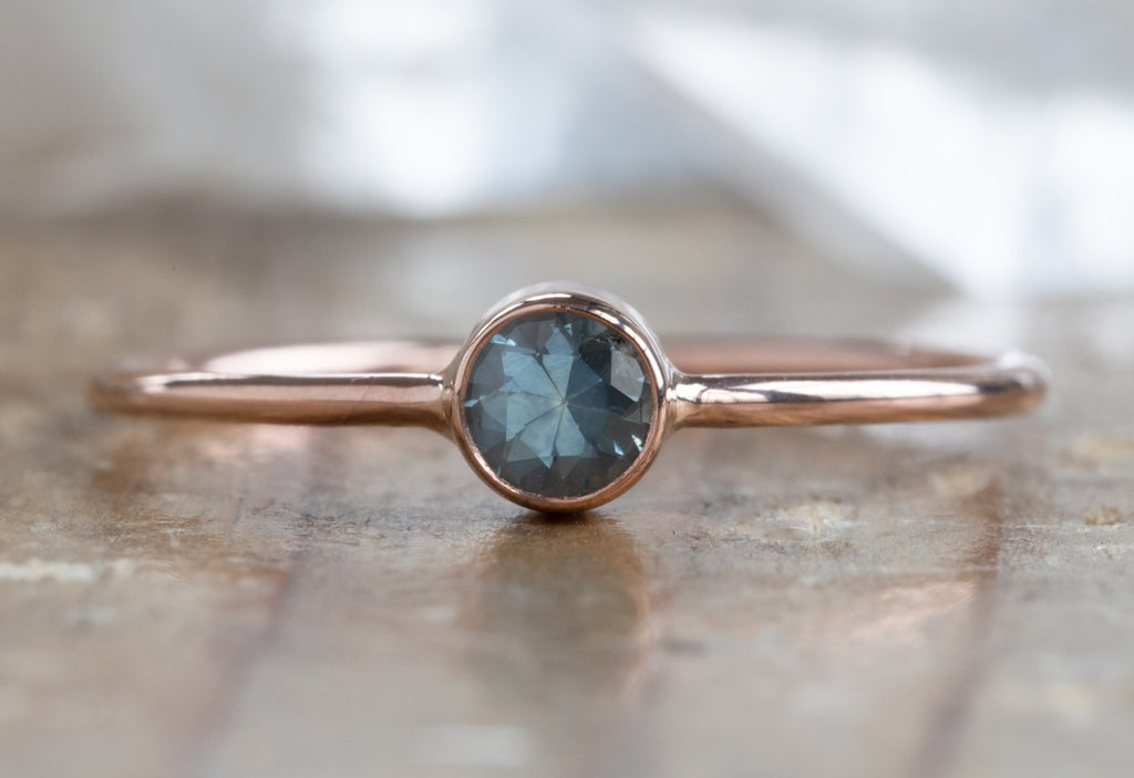 rose gold white gold Round Cut Montana Sapphire Stacking Ring on wood table