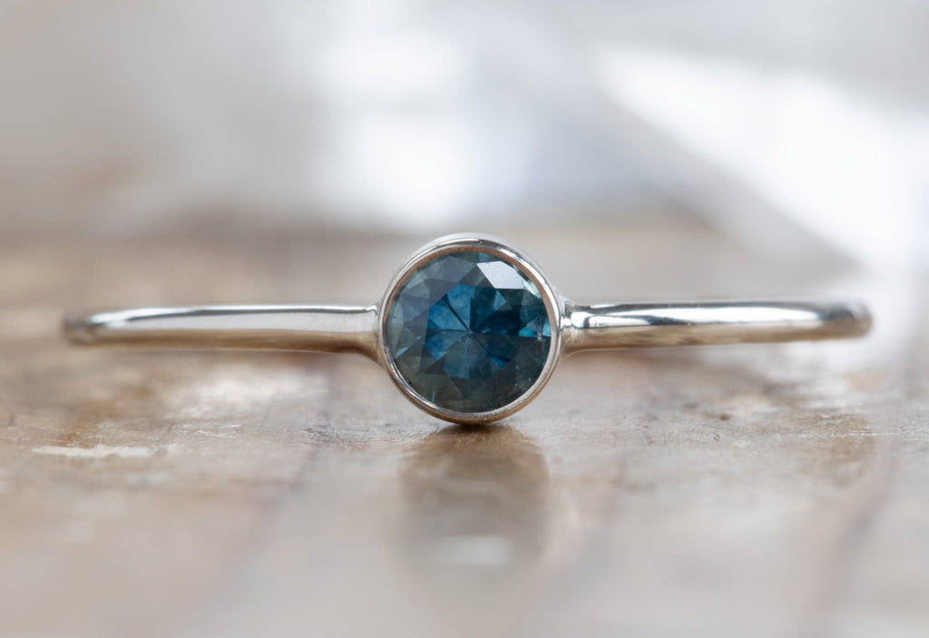 white gold Round Cut Montana Sapphire Stacking Ring on wood table