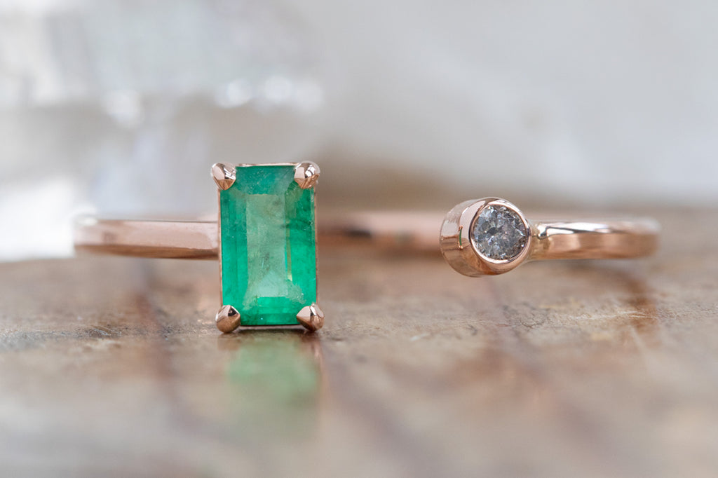 Open Cuff Emerald and Diamond Ring on wood table