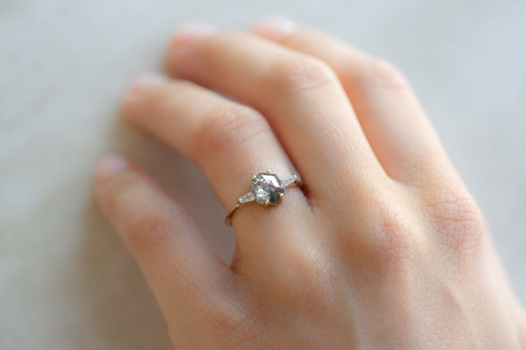 The Ash Ring With a Salt and Pepper Hexagon Diamond on hand
