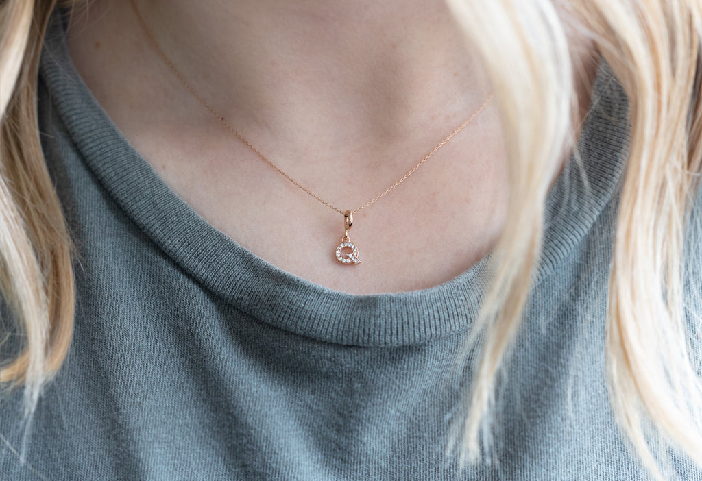"Q" pavé diamond charm necklace on model
