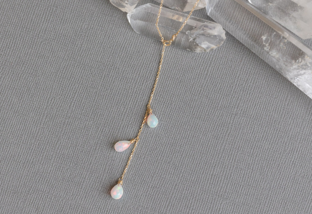Natural Opal Cascade Lariat Necklace on Yellow Gold on Grey Textured Paper