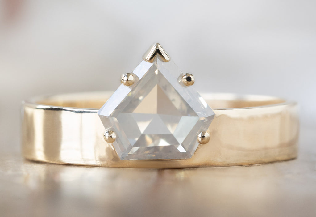 One Of A Kind Cigar Band with a Shield-Cut Opalescent Diamond on Wood Table