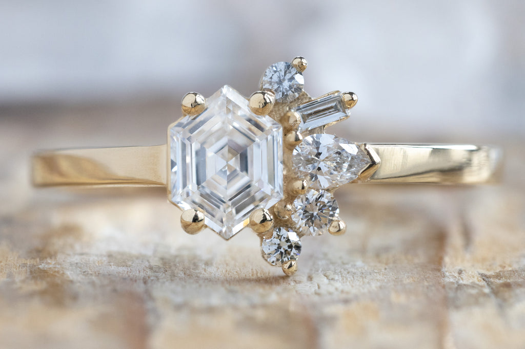 One-of-a-Kind White Hexagon Diamond Cluster Ring on Wood Table
