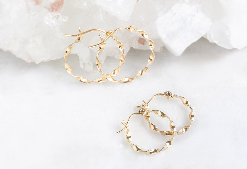 15mm and 20mm Yellow Gold Ribbon Hoops on Marble