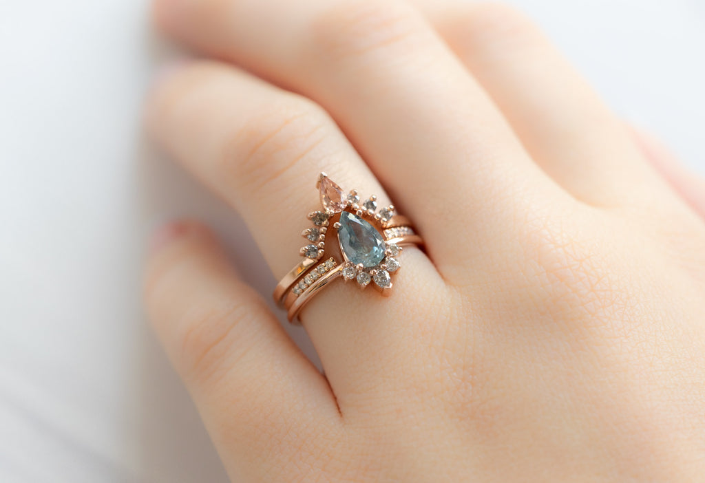 The Aster Ring with a Pear-Cut Montana Sapphire with Stacking Bands on Model