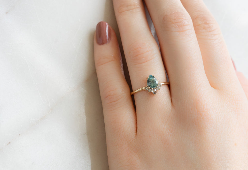 The Aster Ring with a Pear-Cut Montana Sapphire on Model