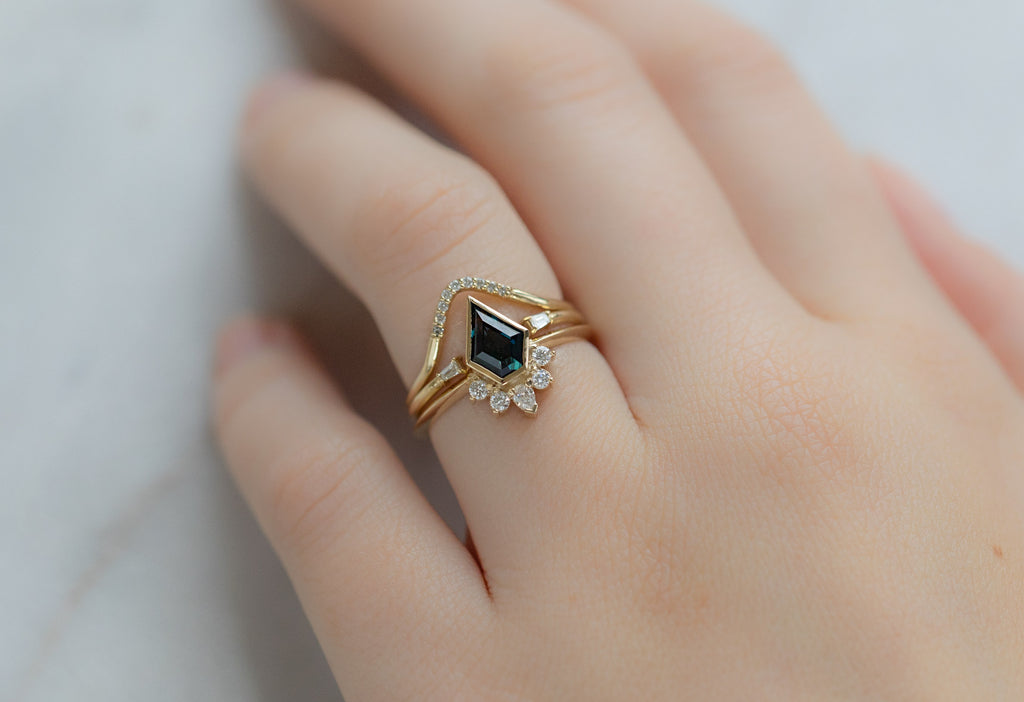The Aster Ring with a Shield-Cut Sapphire with Stacking Bands on Model