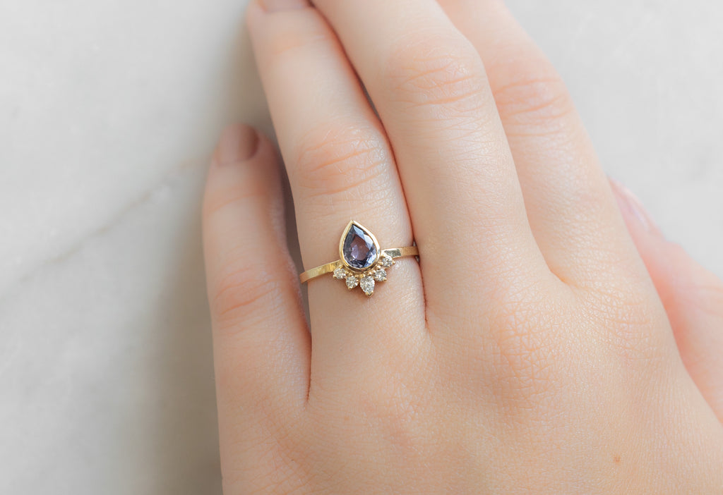 The Aster Ring with a Pear-Cut Violet Sapphire on Model
