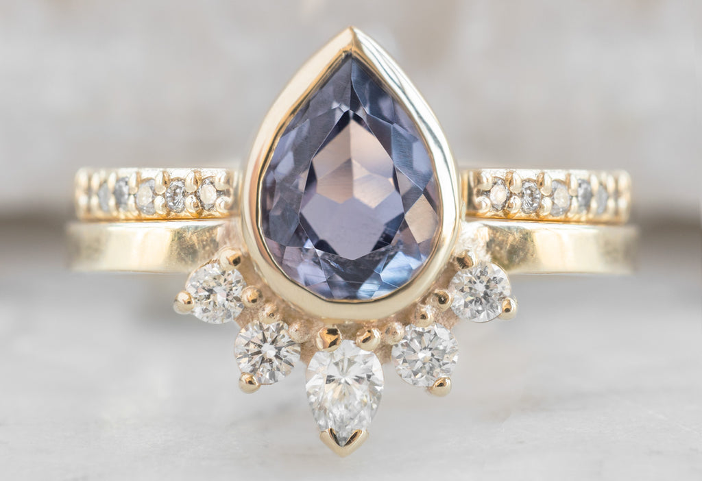 The Aster Ring with a Pear-Cut Violet Sapphire with Open Cuff Pavé Band